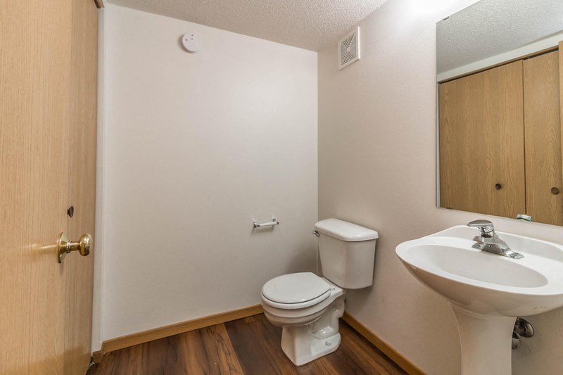 a bathroom with a toilet sink and a mirror