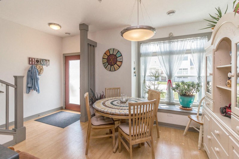 a dining room with a table and chairs and a window