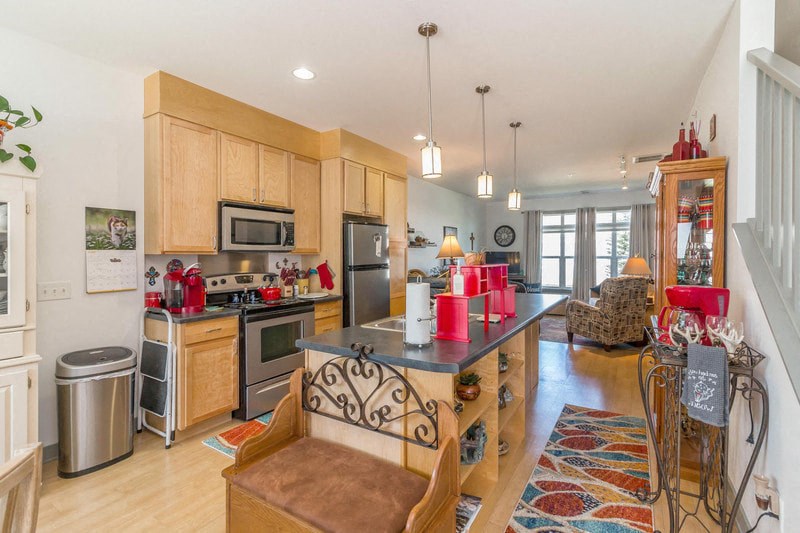 the kitchen is open to the living room and dining room