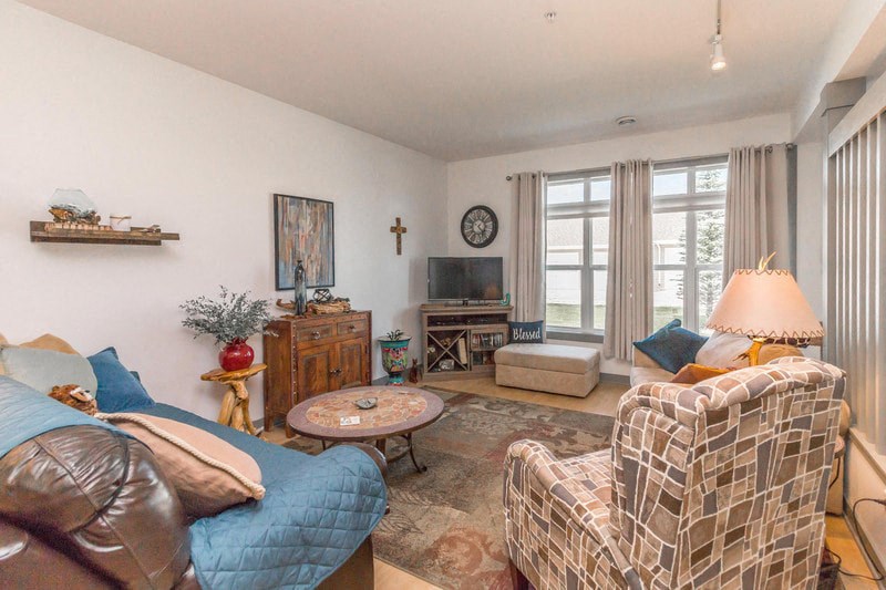 a living room with a couch and a chair and a tv