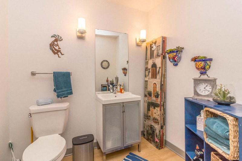 a bathroom with a toilet sink and a mirror