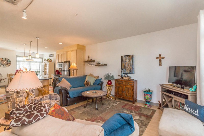 a living room filled with furniture and a tv