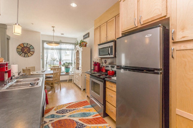 a kitchen with stainless steel appliances and wooden cabinets