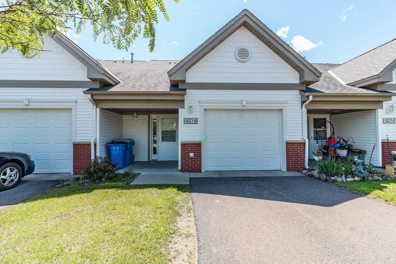 a white house with a driveway in front of it