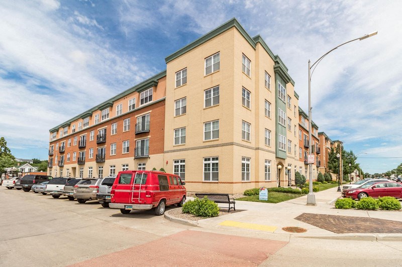 a red van parked in front of an apartment building