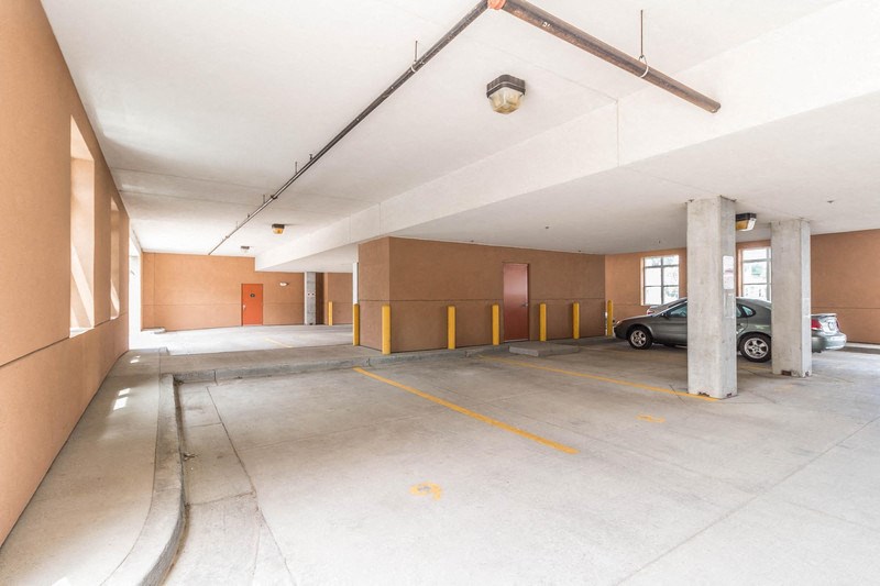 a parking garage with a car parked in it