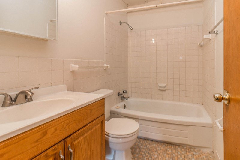 a bathroom with a sink toilet and a bath tub