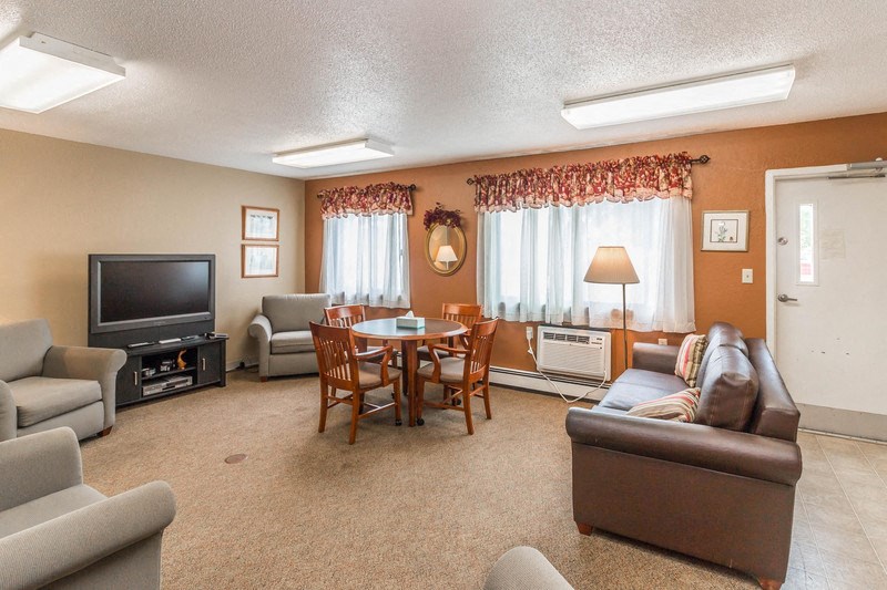 a living room with couches a table and a television