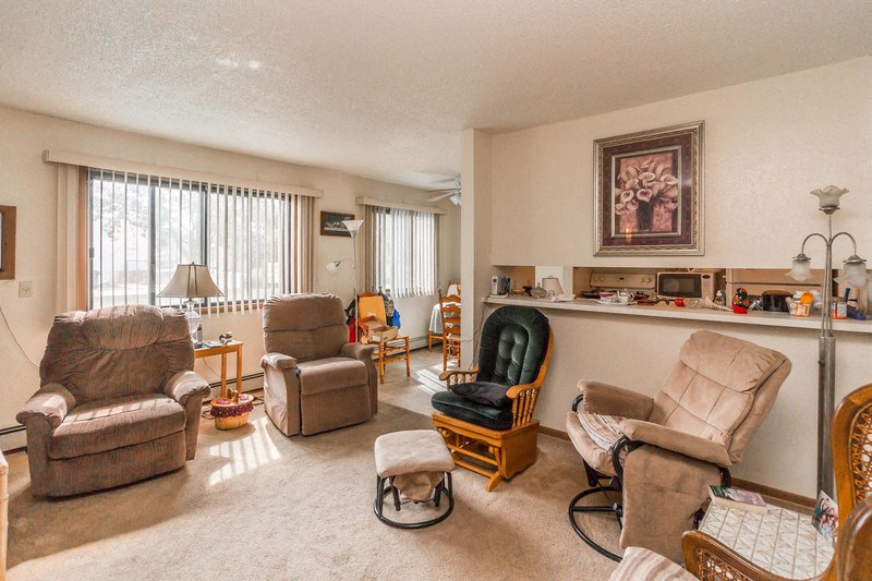 the living room has a lot of chairs and a bar