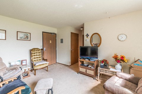 a living room filled with furniture and a tv