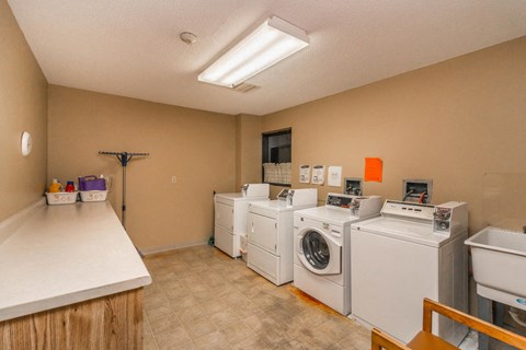 a laundry room filled with washes and dryers