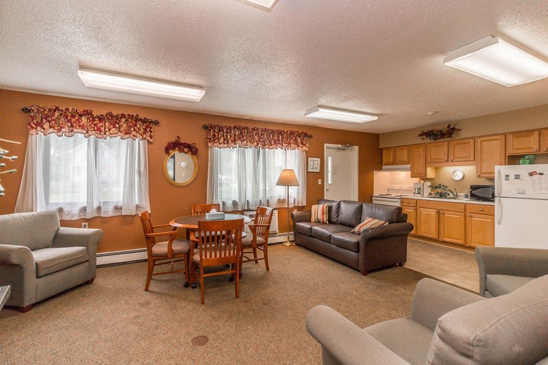 a living room with couches and chairs and a table