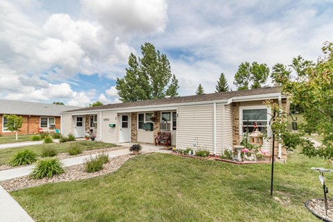 a small house with a lawn and a driveway