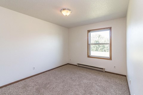 the living room of an empty house with a window