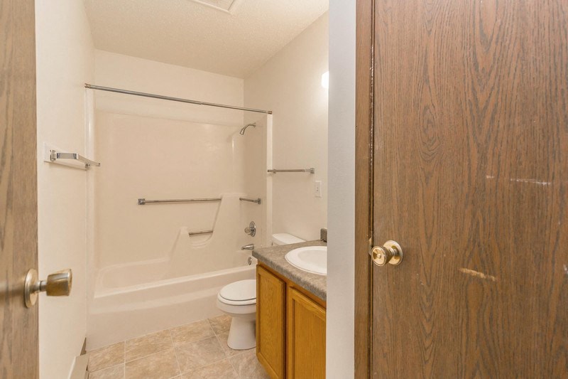 a bathroom with a toilet and a sink and a shower