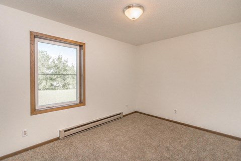 the living room of an empty house with a window