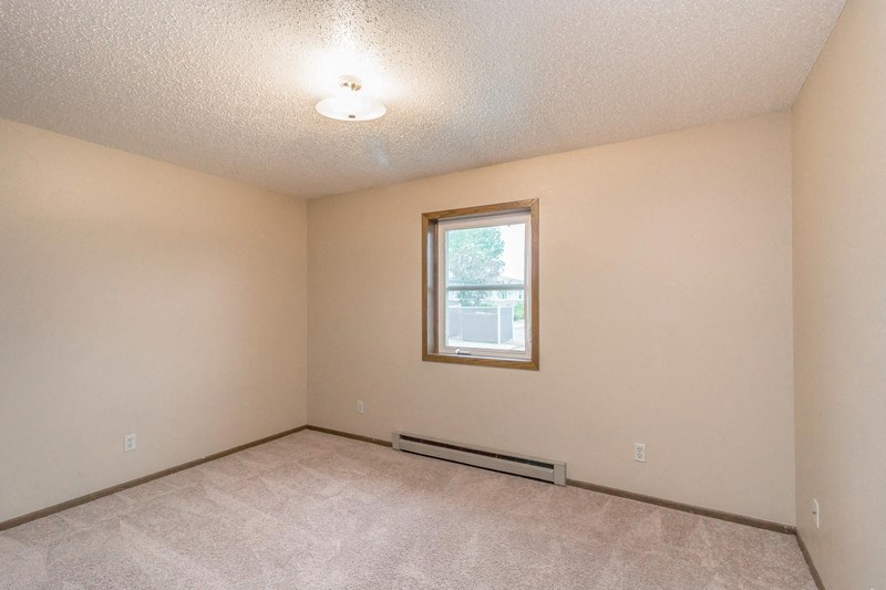 the living room of an empty house with a window