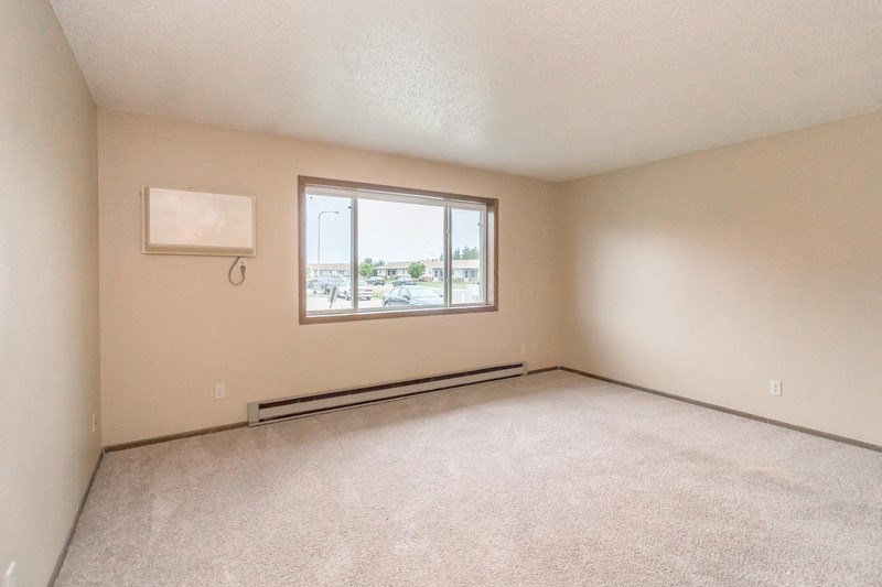 the living room of an empty house with a window