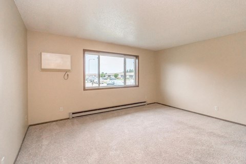 the living room of an empty house with a window
