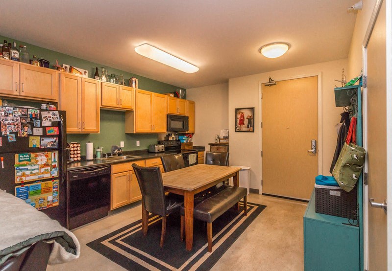 a kitchen and dining room with a table and a refrigerator