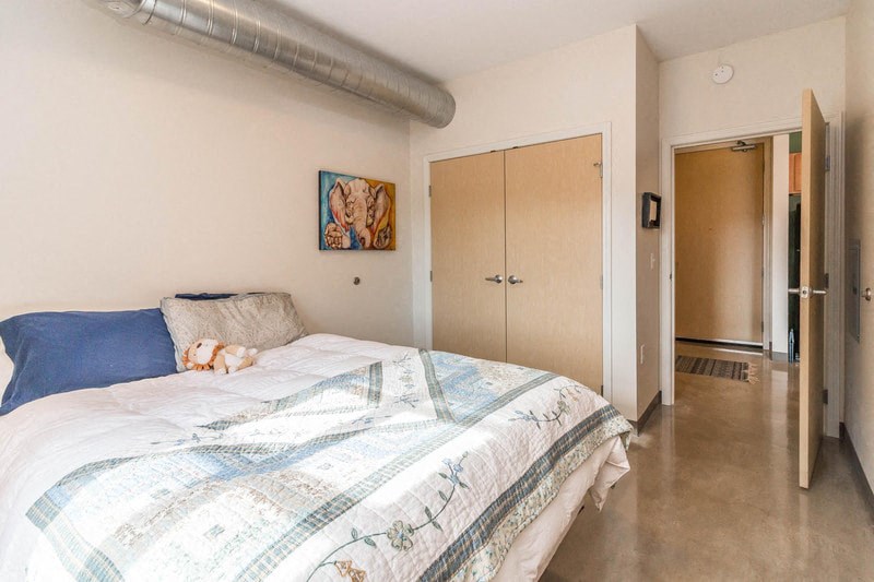 a bedroom with a bed and a dog