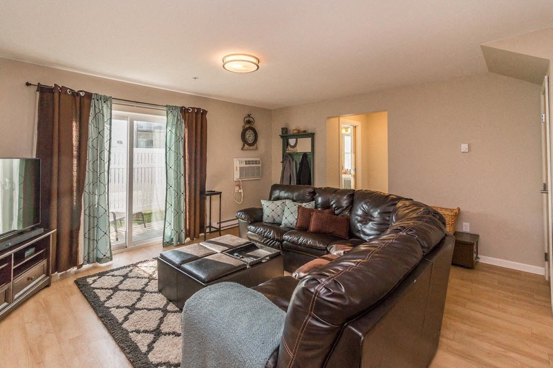 a living room with a leather couch and a tv