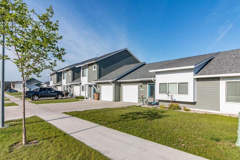 a row of houses with a car parked in front of them