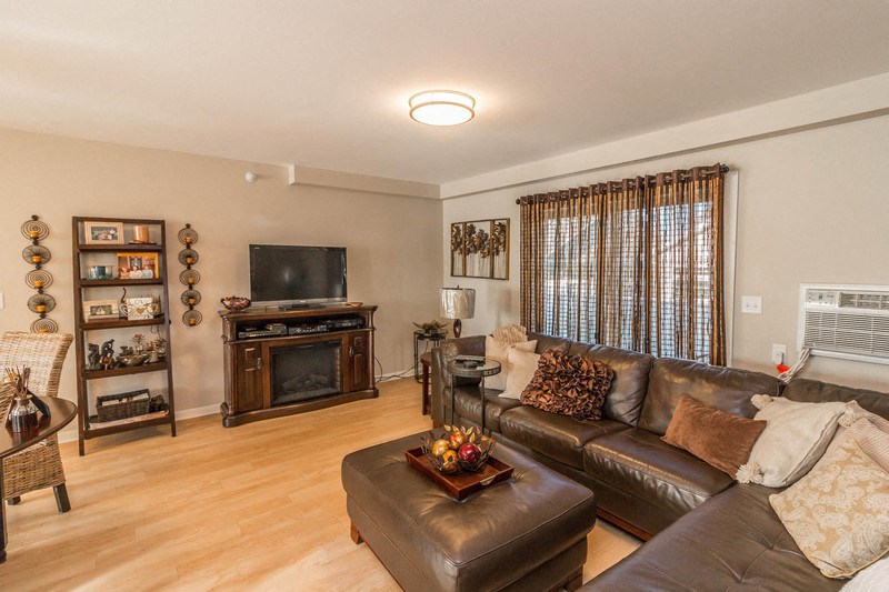 a living room with a leather couch and a television