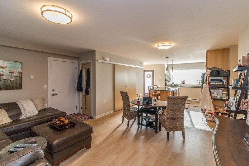 a living room and dining room with a couch and a table