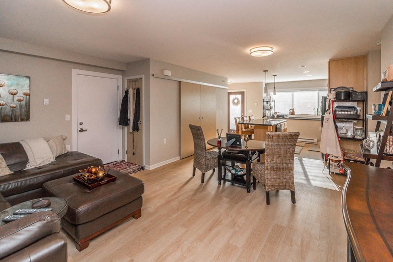 a living room and dining room with a couch and a table
