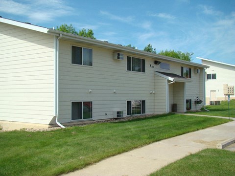 a white house with a lawn and a sidewalk