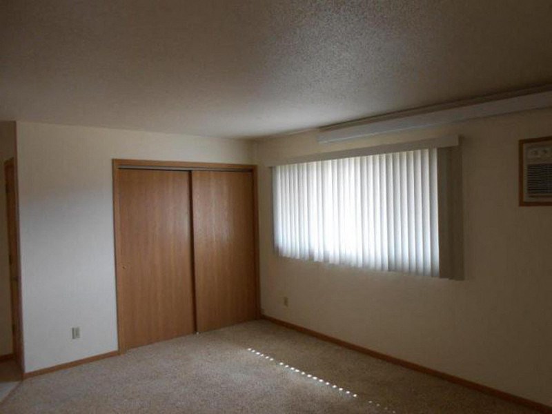 an empty room with a window and a door