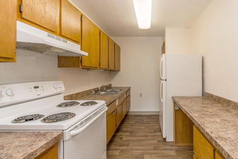our apartments have a kitchen with a stove and a refrigerator