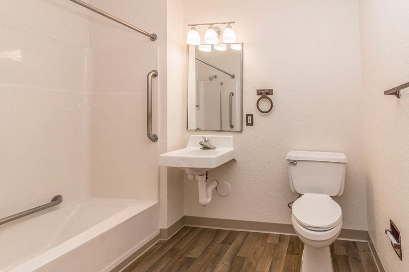 a bathroom with a toilet and a sink and a bath tub