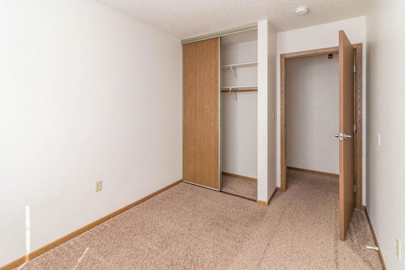 a bedroom with a closet and an open door