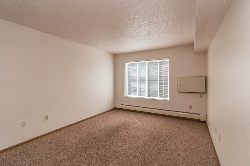 the living room of an empty house with a window