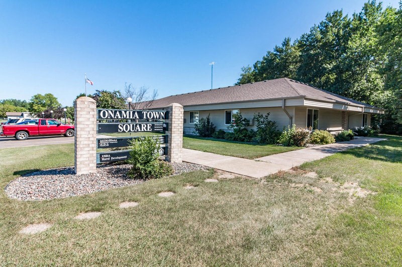 a building with a sign that reads omana town square