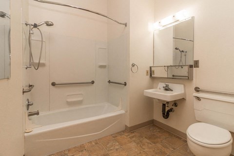 a bathroom with a shower and a sink and a toilet