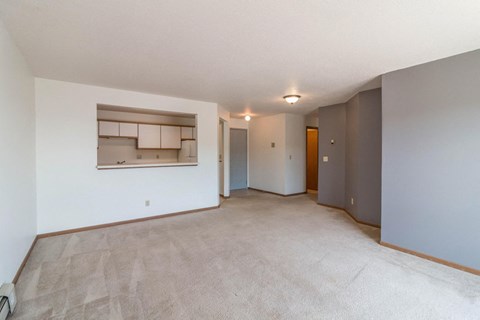 an empty living room and kitchen in a house