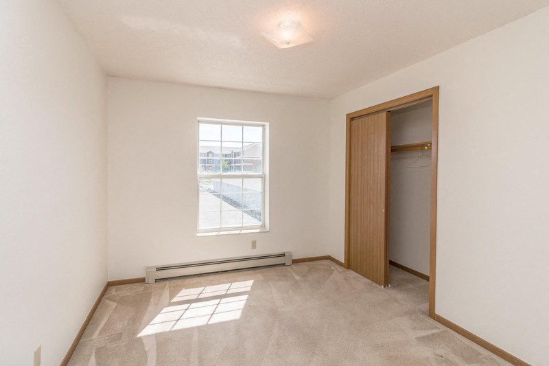 an empty room with a window and a door