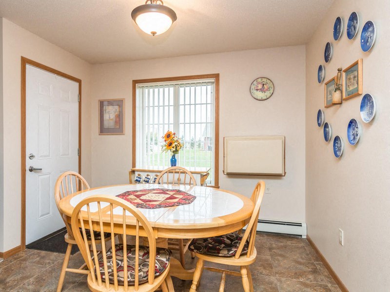 a dining room with a table and chairs and a window