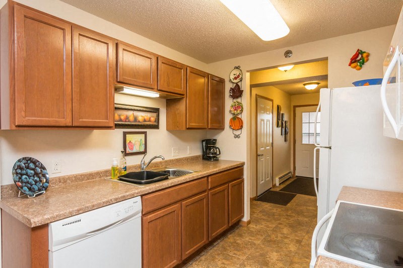 a kitchen with a sink and a refrigerator