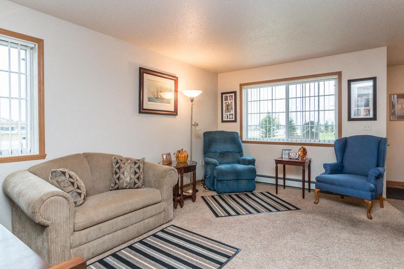 a living room with a couch and two chairs