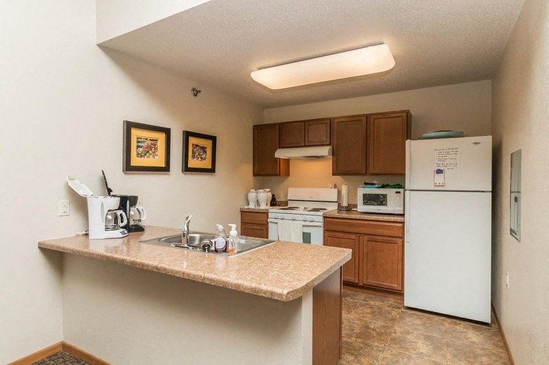 a kitchen with a granite counter top and a white refrigerator