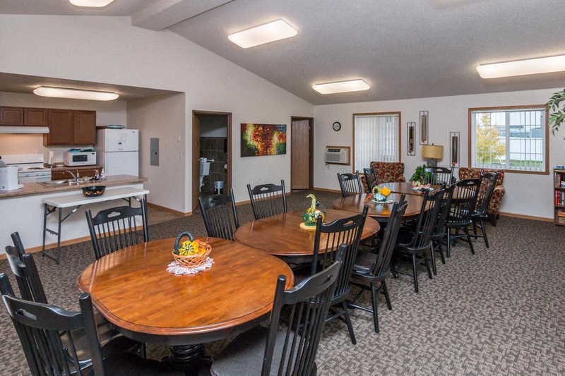 a dining room and kitchen with a table and chairs