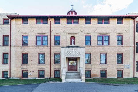 A large building with a cross on top of it.