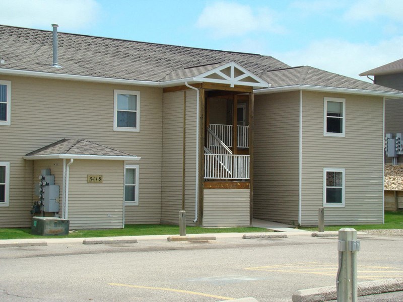 a house with a porch and a street in front of it