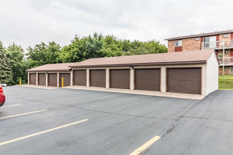 a parking lot with a row of garages