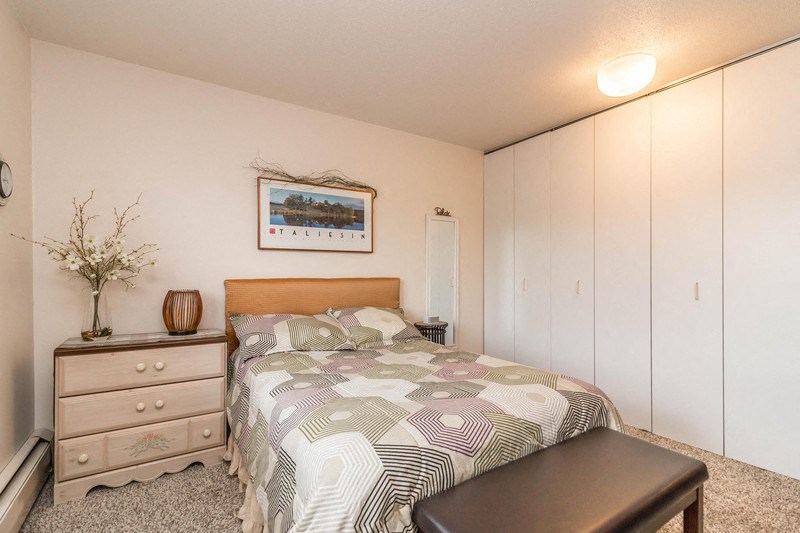 a bedroom with a bed and a dresser