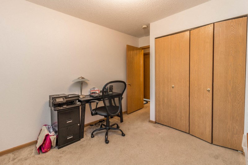 a home office with a desk and a filing cabinet
